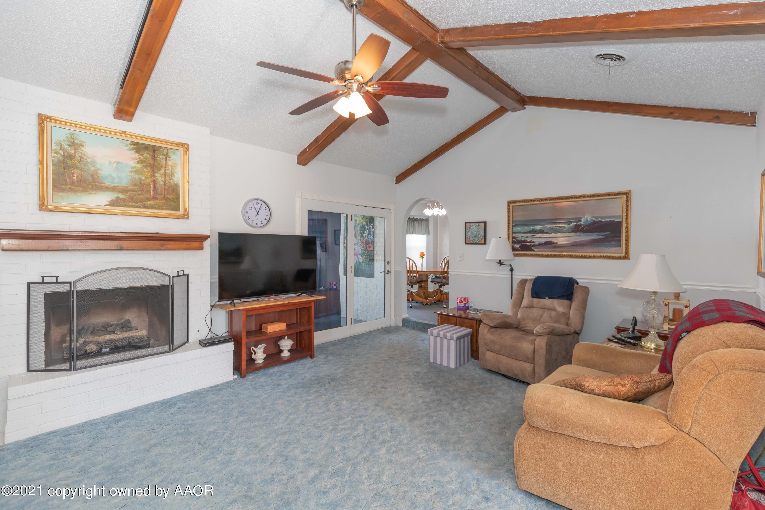 5104 McCarty Boulevard Amarillo, TX 79110 - Photo 5 of 35 a living room with furniture a fireplace and a flat screen tv