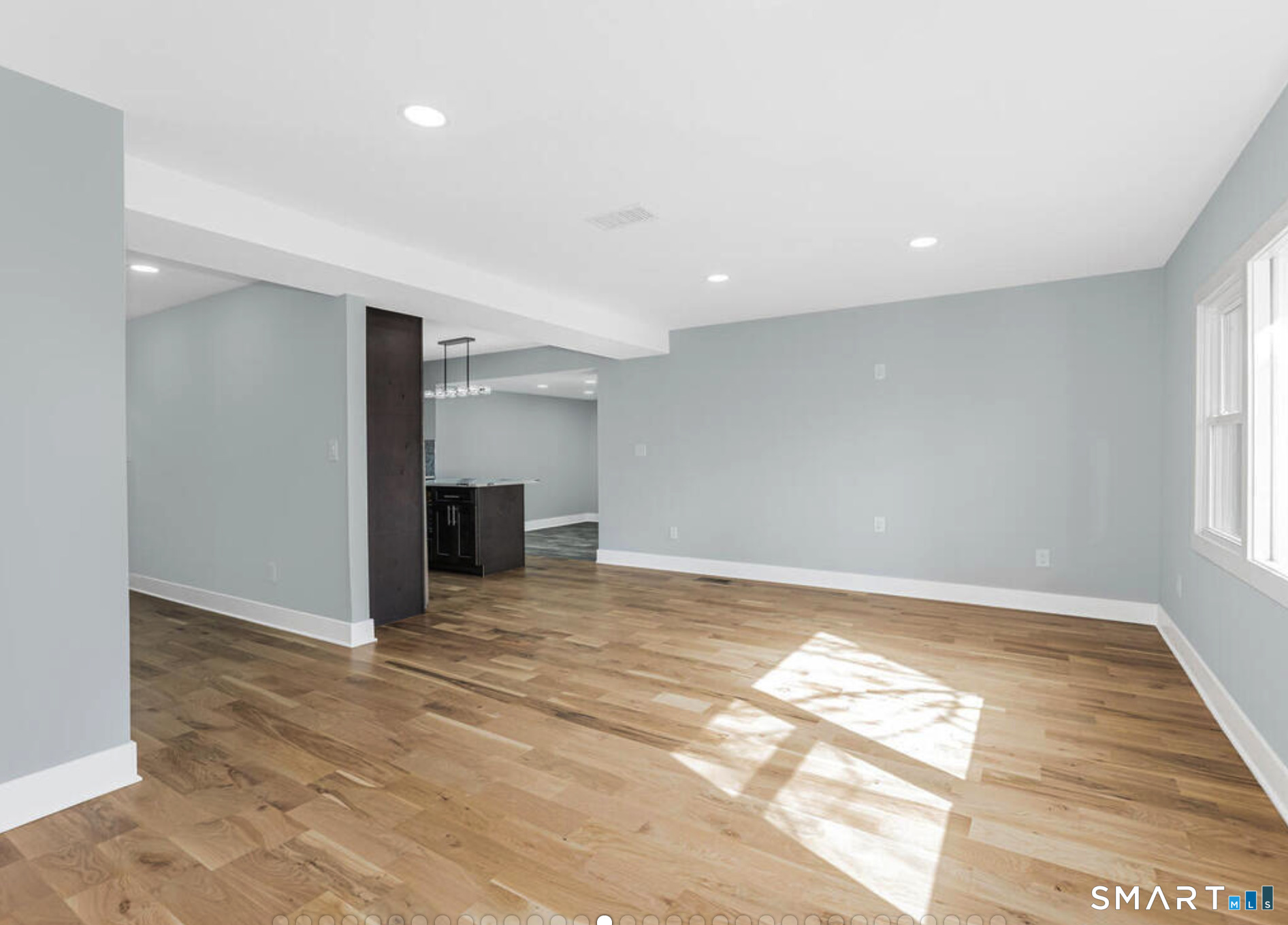 233 Glenbrook Road Stamford, CT 06906 - Photo 3 of 20 a view of an empty room with wooden floor and a window
