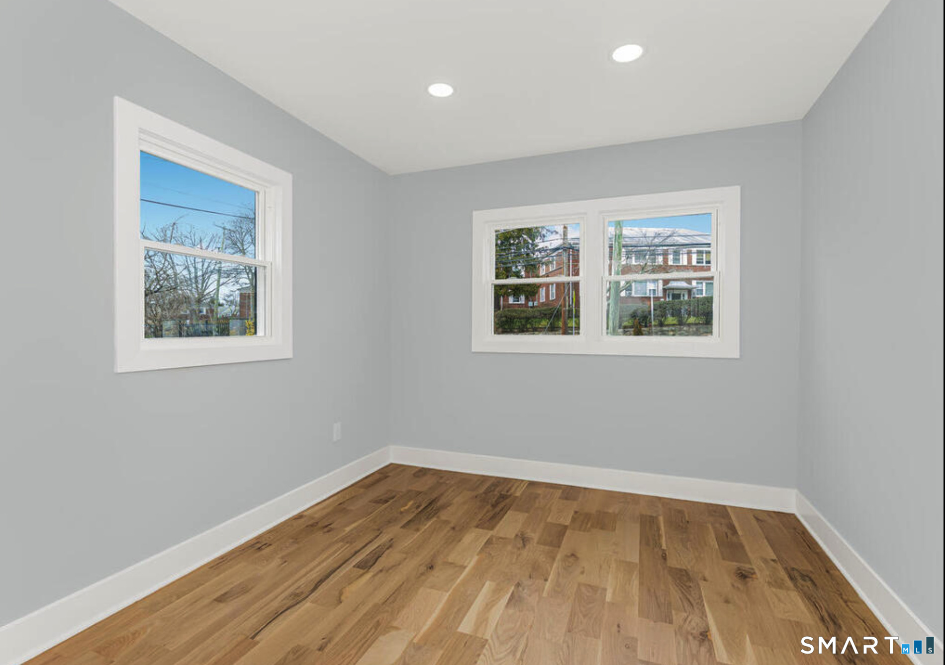 233 Glenbrook Road Stamford, CT 06906 - Photo 4 of 20 a view of empty room with wooden floor and fan