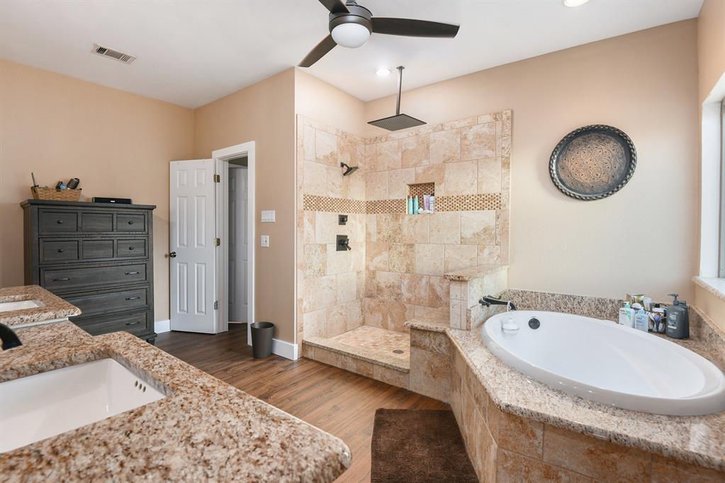 12384 J J Rendon Road Burleson, TX 76028 - Photo 19 of 31 a bathroom with a tub sink shower and mirror