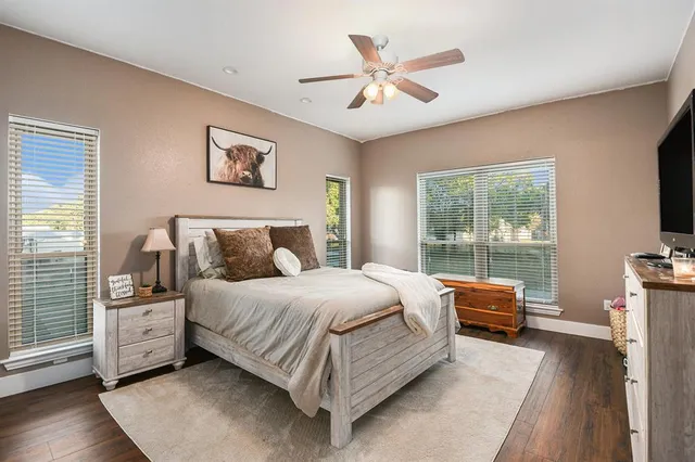 a bedroom with a large bed and a chandelier