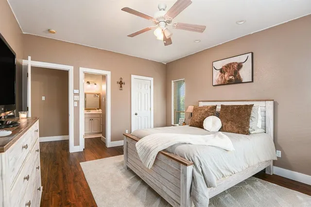 a bathroom with a granite countertop sink a toilet and a mirror