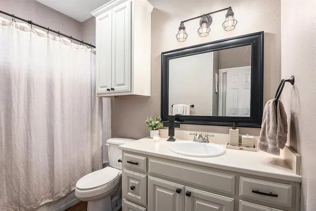 a view of a livingroom with furniture and a flat screen tv