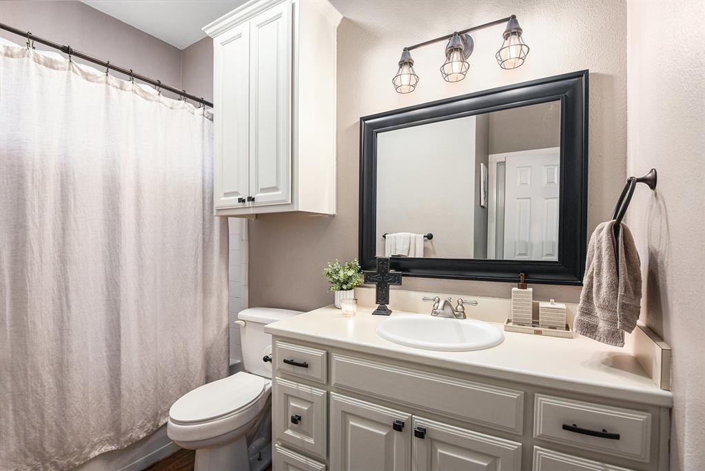 12384 J J Rendon Road Burleson, TX 76028 - Photo 25 of 31 a bathroom with a sink vanity mirror and toilet