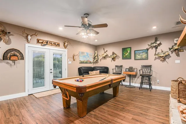 a living room with stainless steel appliances kitchen island granite countertop furniture and a fireplace