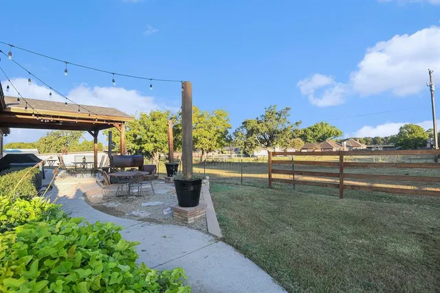 a view of a house with backyard porch and sitting area