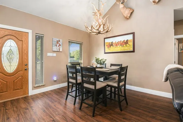 a view of a dining room with furniture wooden floor and chandelier