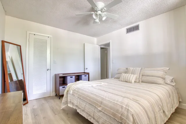 a bedroom with a bed and a large mirror