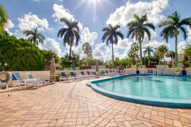 a view of swimming pool with outdoor seating and plants