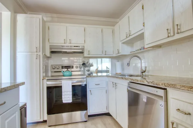 a kitchen with stainless steel appliances granite countertop a refrigerator sink and cabinets
