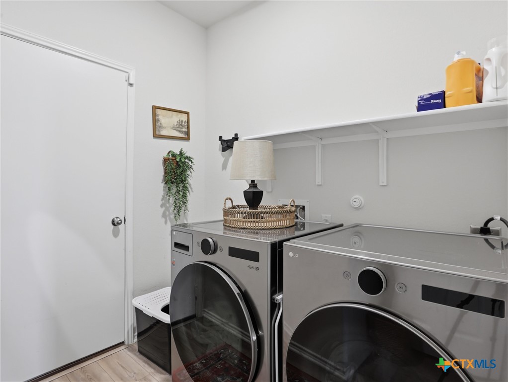 198 Orange Road Buda, TX 78610 - Photo 17 of 28 a utility room with dryer and washer