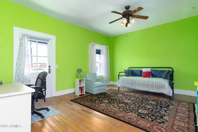 a bedroom with furniture and a flat screen tv