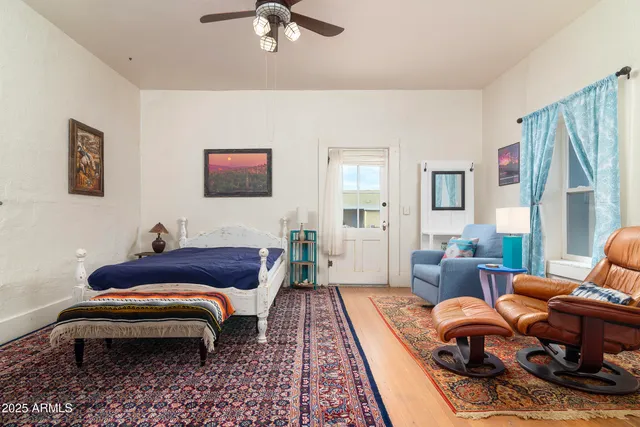 an empty room with a window and wooden floor