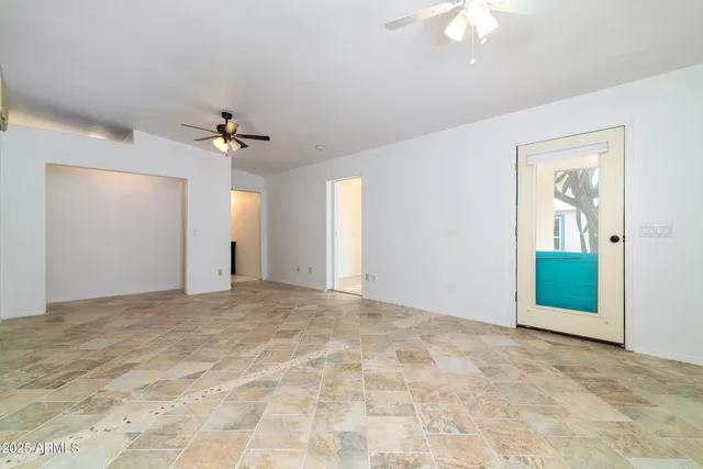 a view of a chairs with potted plants in front of house