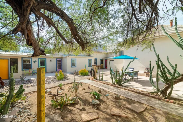 a house that has a tree in front of it