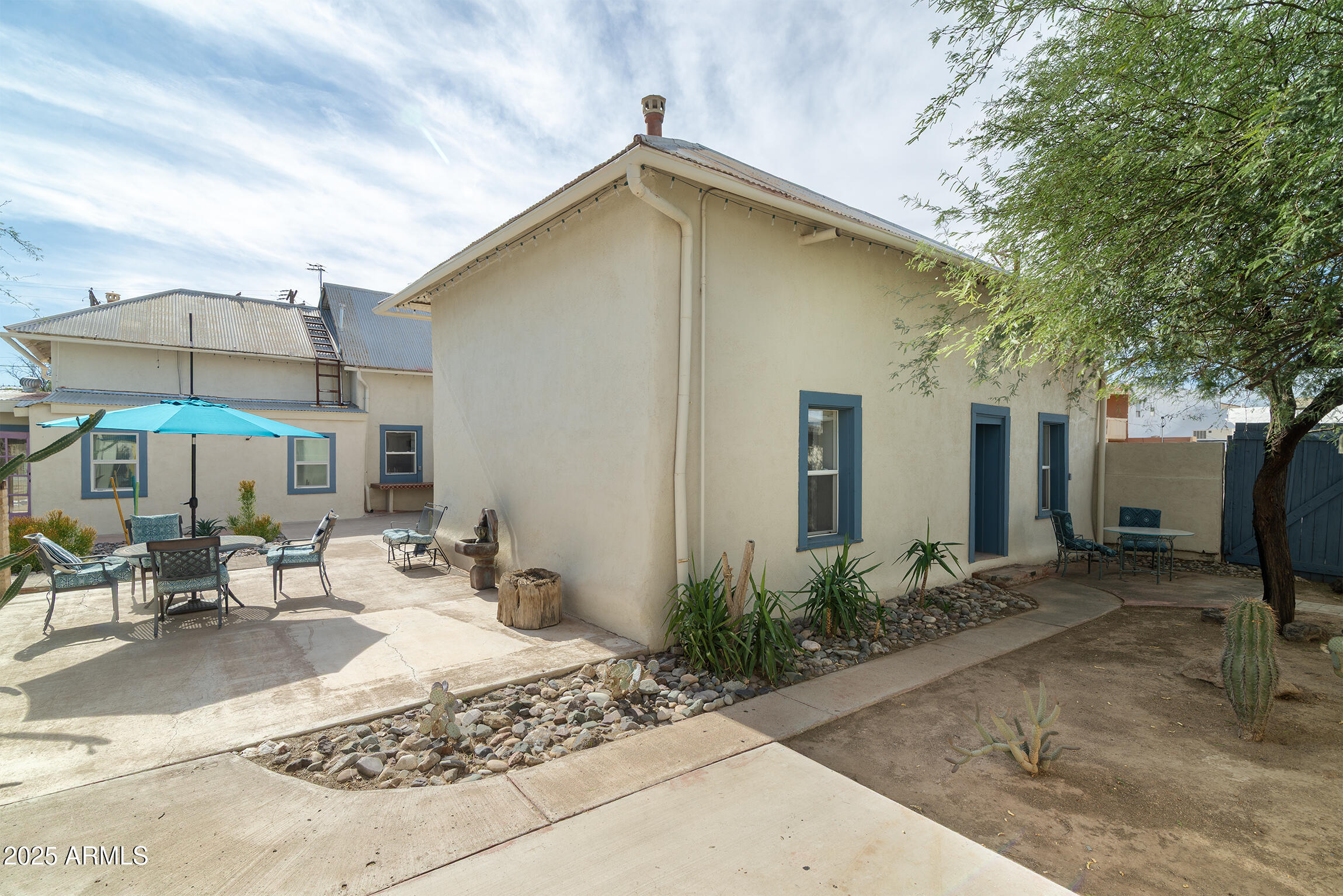 321 Bailey Street Florence, AZ 85132 - Photo 47 of 67 a patio with a table and chairs under an umbrella