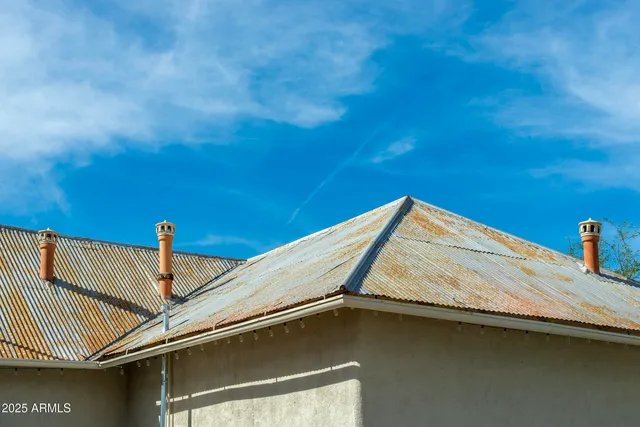 a front view of a house with a road