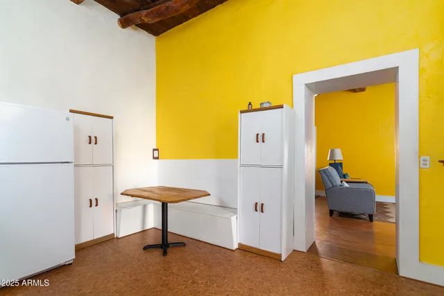 a kitchen with stainless steel appliances granite countertop a stove a refrigerator and a dining table with wooden floor