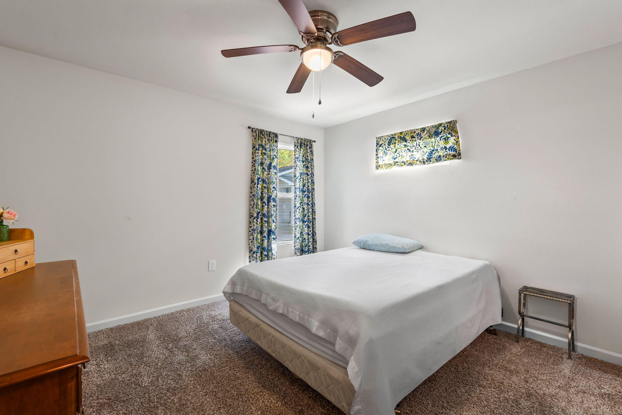 8528 Laredo Street Navarre, FL 32566 - Photo 6 of 16 a bedroom with a bed and a chandelier