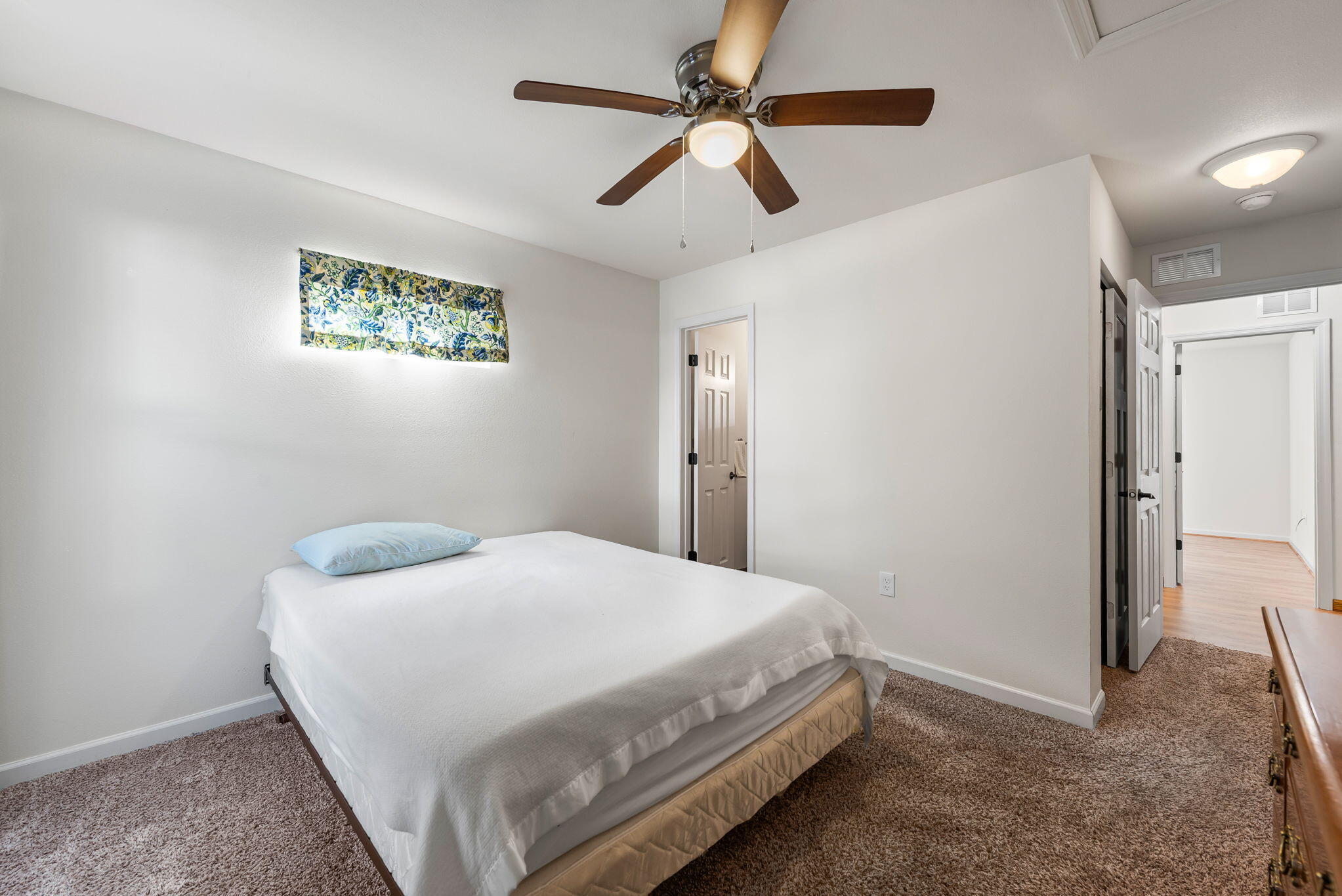 8528 Laredo Street Navarre, FL 32566 - Photo 7 of 16 a bedroom with a bed and a ceiling fan