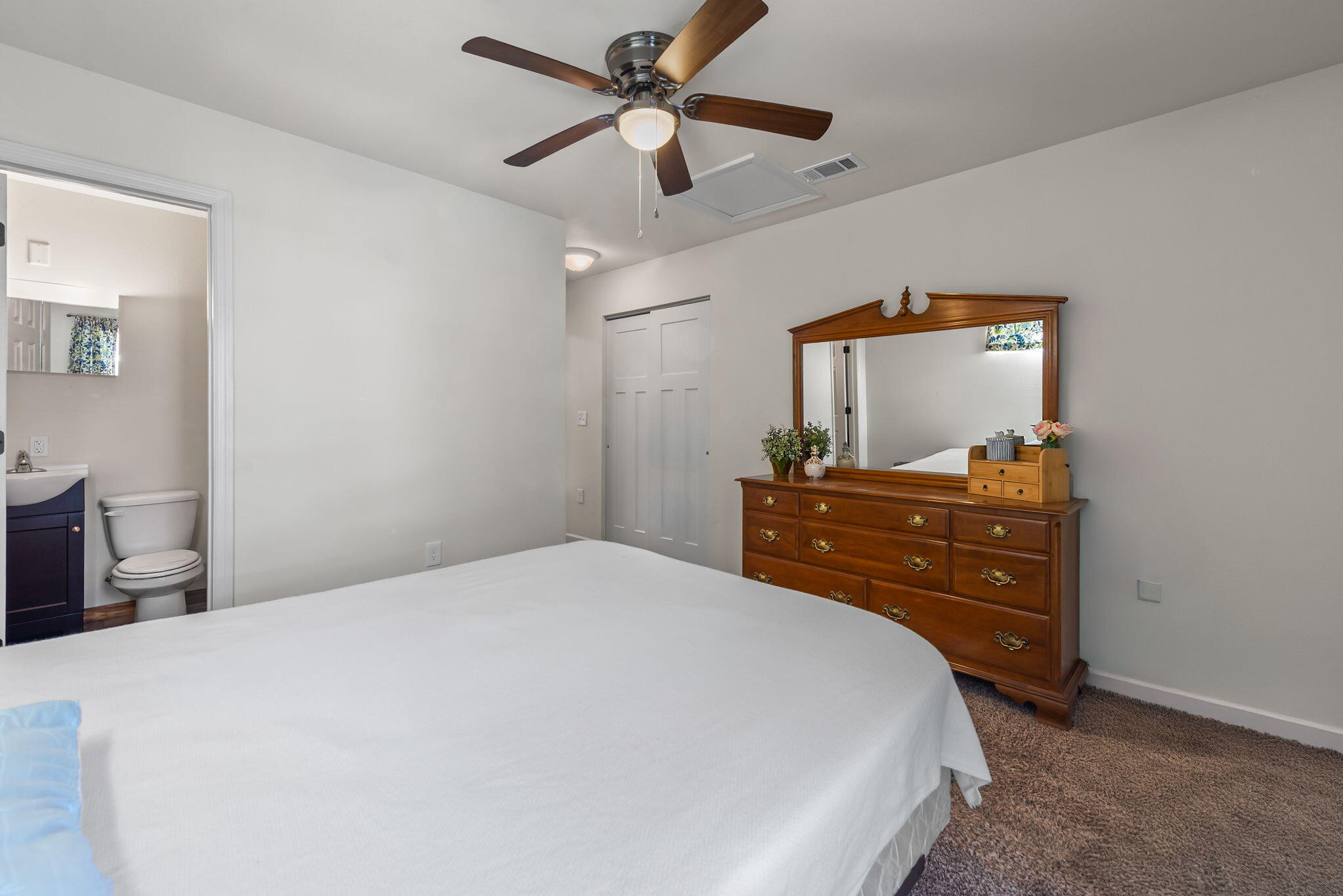 8528 Laredo Street Navarre, FL 32566 - Photo 8 of 16 a bedroom with a bed and a dresser