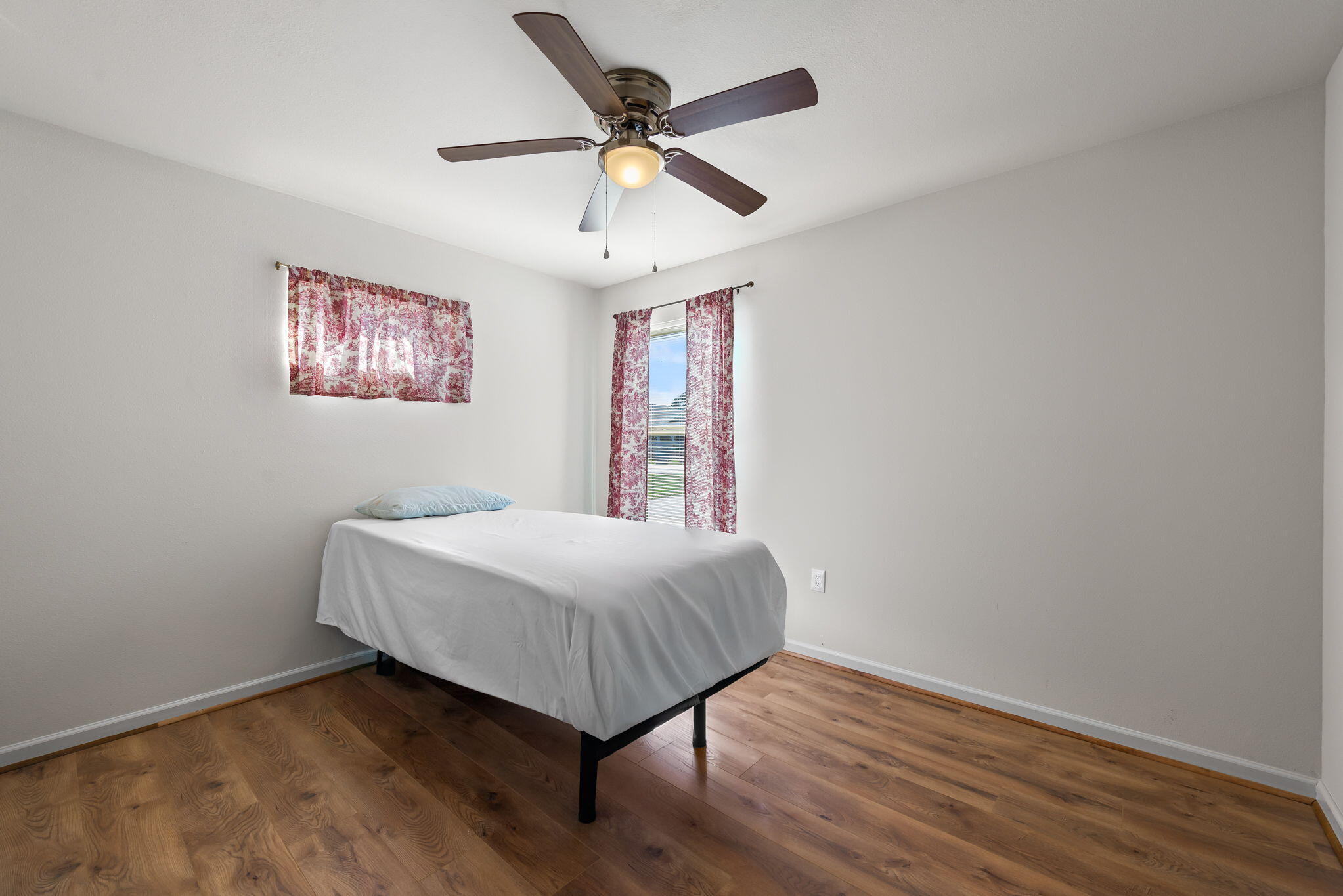 8528 Laredo Street Navarre, FL 32566 - Photo 10 of 16 a bedroom with a bed and a ceiling fan