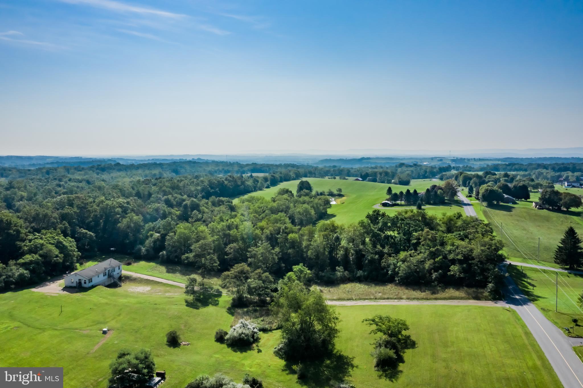 an aerial view of a golf course with a lake view
