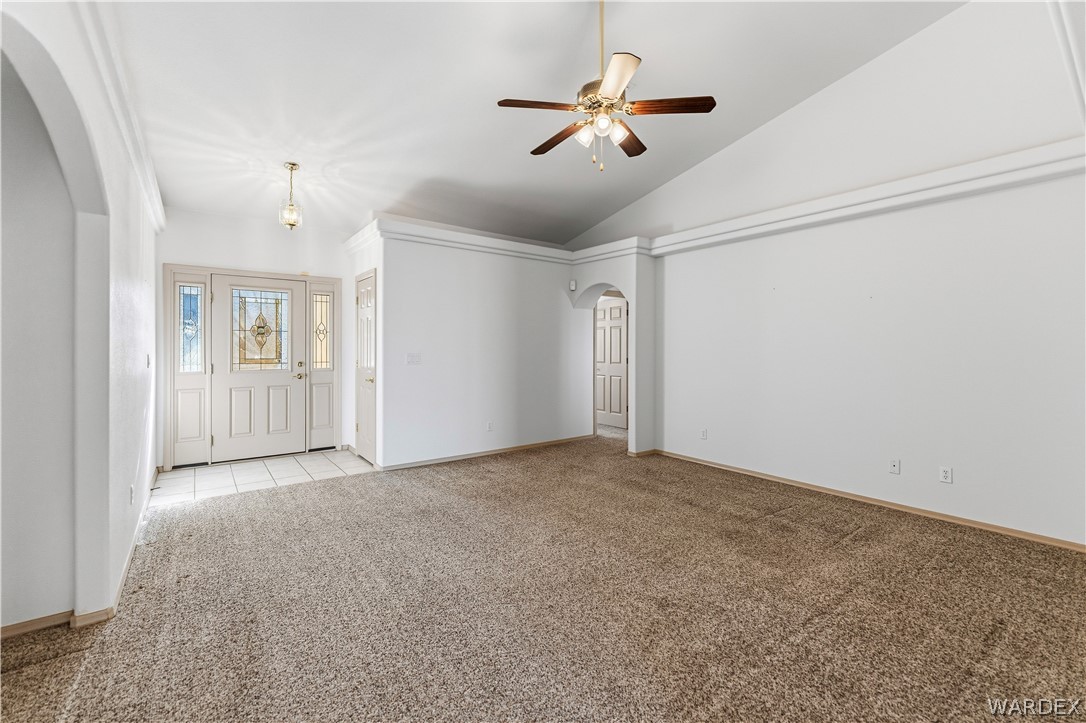 3973 Prairie View Drive Kingman, AZ 86409 - Photo 13 of 34 The living area features vaulted ceilings, a ceiling fan, and carpeted floors, with a tiled entry way