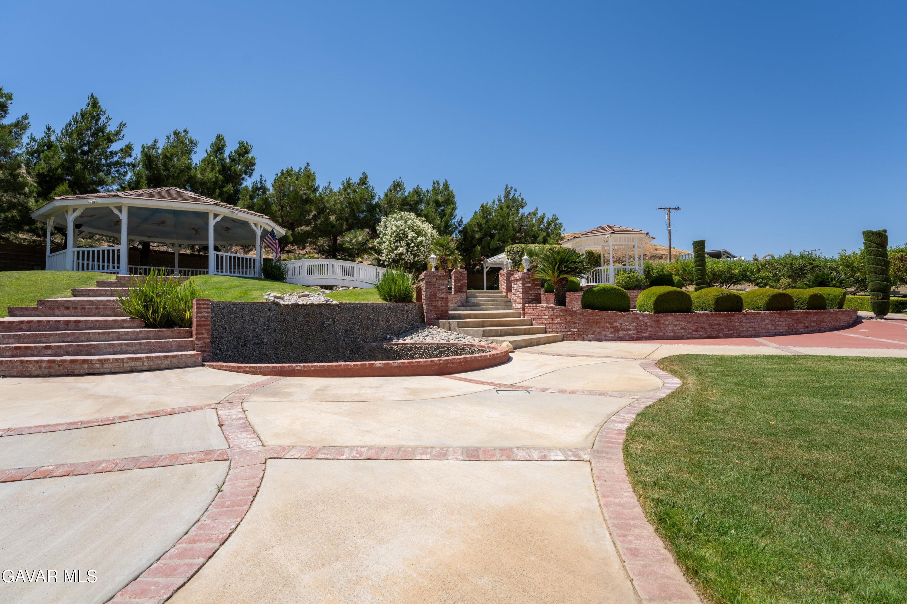 5801 Hacienda Ranch Road Palmdale, CA 93551 - Photo 54 of 69 a front view of a house with a yard