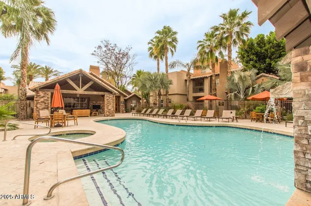 a view of house with swimming pool outdoor seating