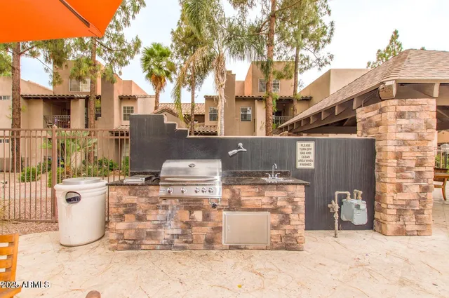 a view of a patio with a table and chairs
