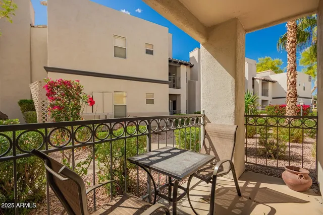 a view of a chairs and table in a backyard