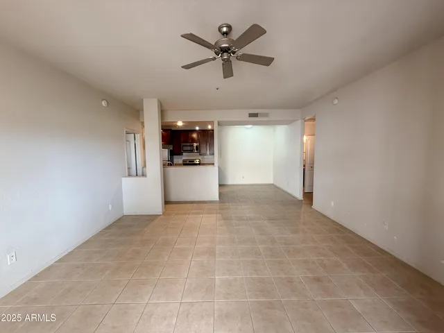 a view of a livingroom with a kitchen space a sink and a stove