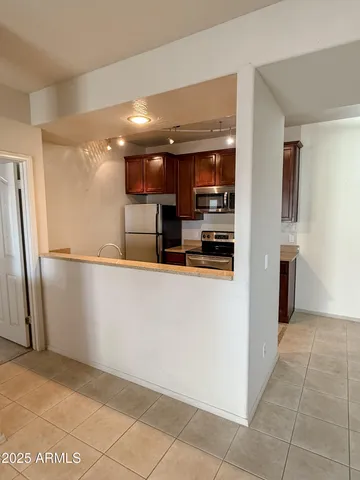 a view of kitchen with refrigerator and window