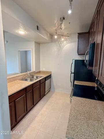 a spacious bathroom with a granite countertop sink a toilet a mirror and vanity