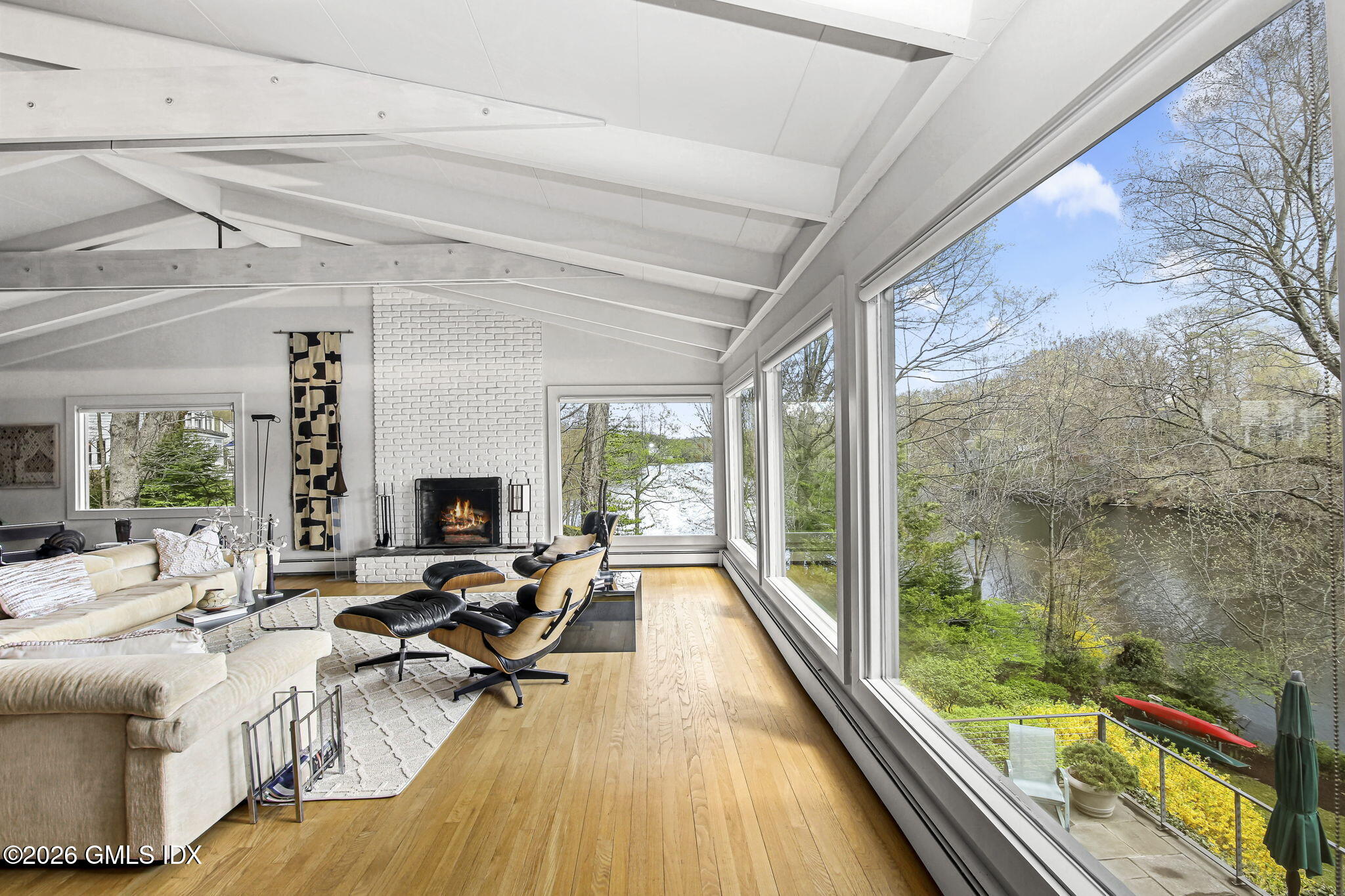 185 Valley Road Cos Cob, CT 06807 - Photo 13 of 38 a living room with furniture stove and a table