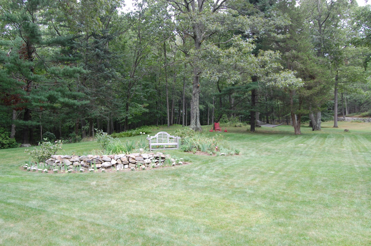61 Hopewell Woods Road Redding, CT 06896 - Photo 19 of 22 a view of a fire pit in a yard