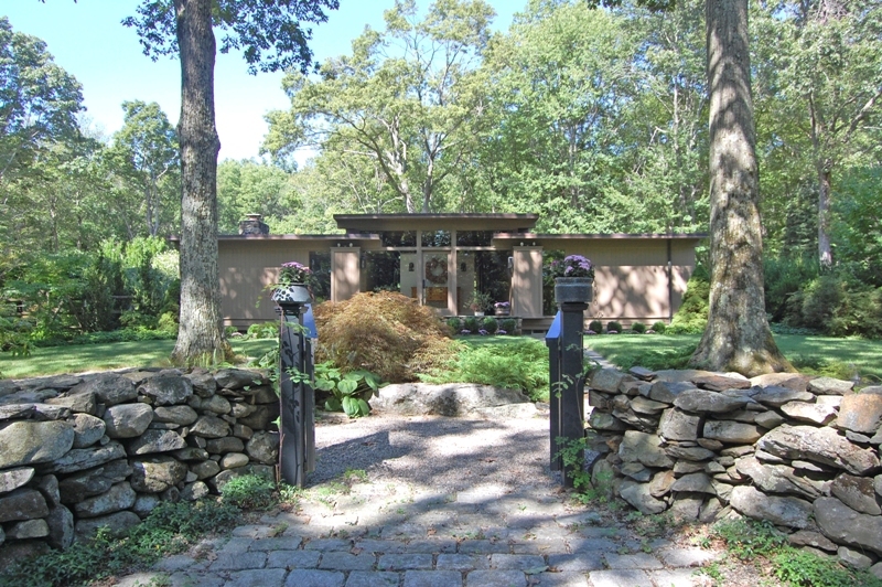 61 Hopewell Woods Road Redding, CT 06896 - Photo 20 of 22 a view of a patio with table and chairs potted plants and large tree
