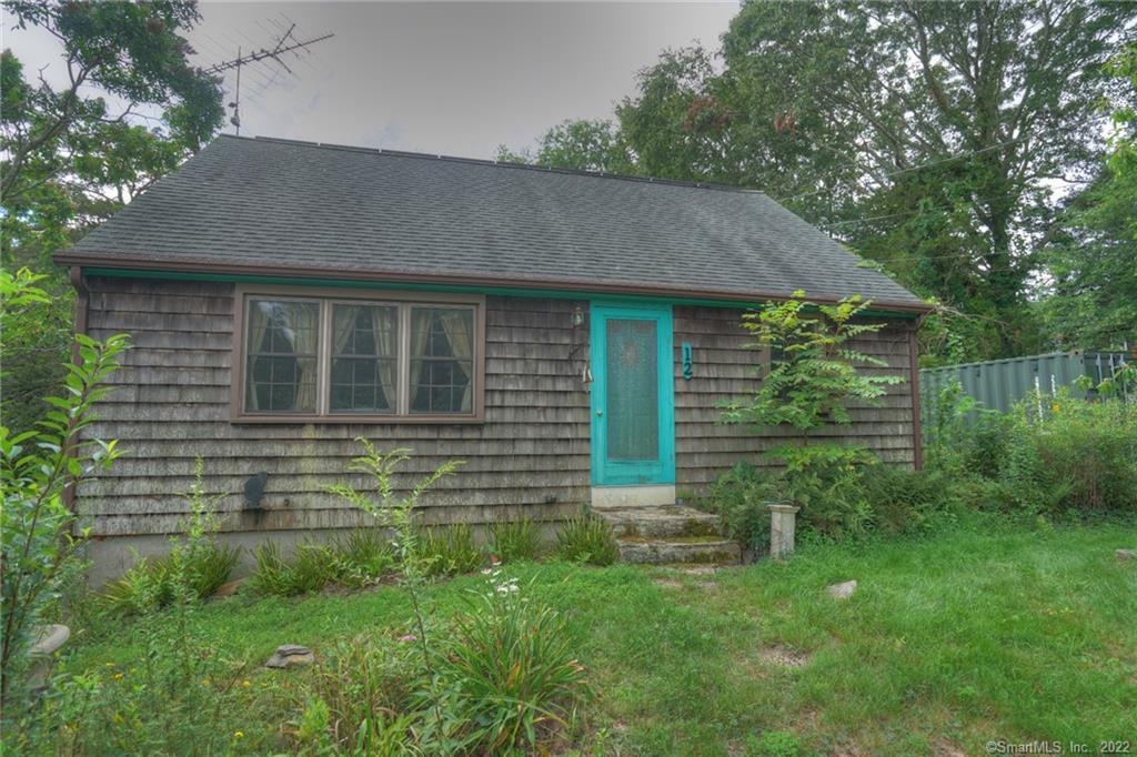 12 Little Gull Lane Groton, CT 06355 - Photo 1 of 1 a brick house with a yard plants and large trees