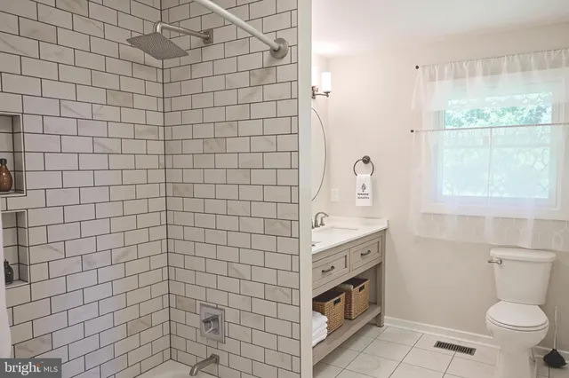 a bathroom with a sink a toilet and window