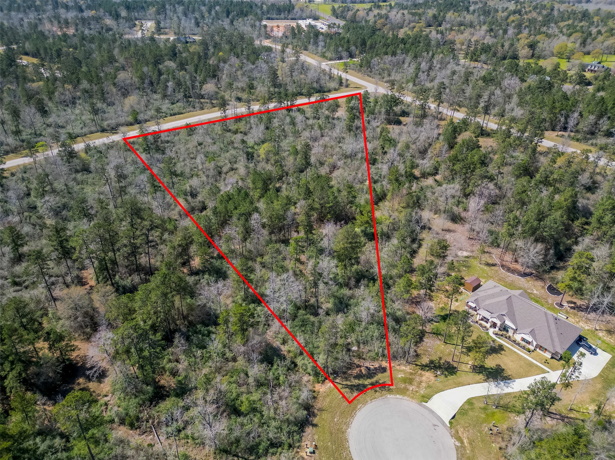 a aerial view of a house with a yard and mountain view
