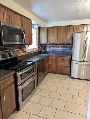 a kitchen with a refrigerator stove and microwave