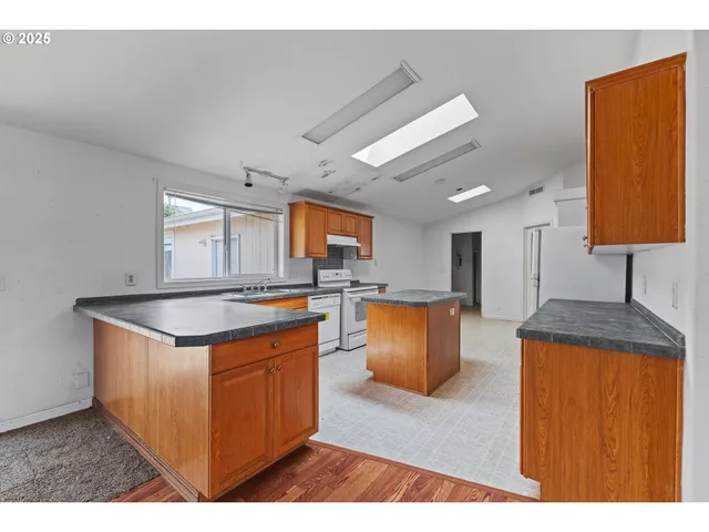 a kitchen with stainless steel appliances granite countertop a stove and a sink