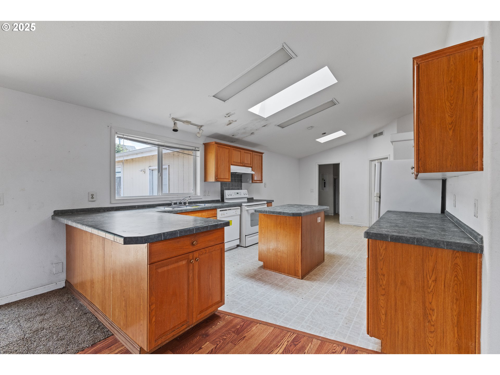 1829 East Willow Street Myrtle Point, OR 97458 - Photo 11 of 37 a kitchen with stainless steel appliances granite countertop a stove and a sink