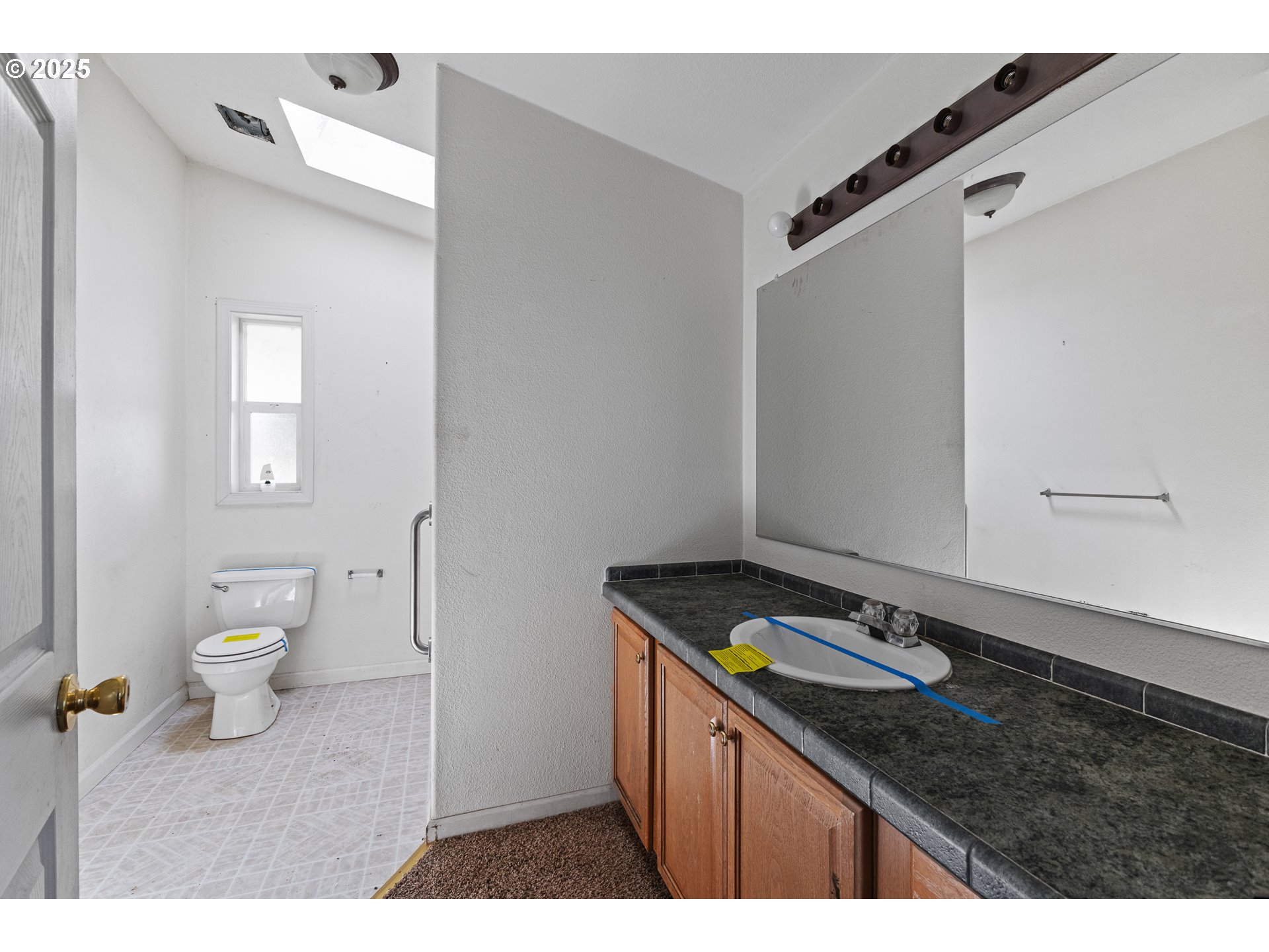 1829 East Willow Street Myrtle Point, OR 97458 - Photo 25 of 37 a bathroom with a sink a toilet and a mirror