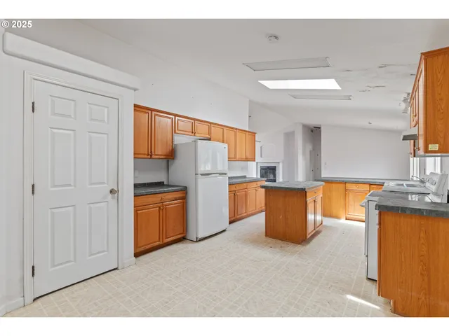 a kitchen with refrigerator and window