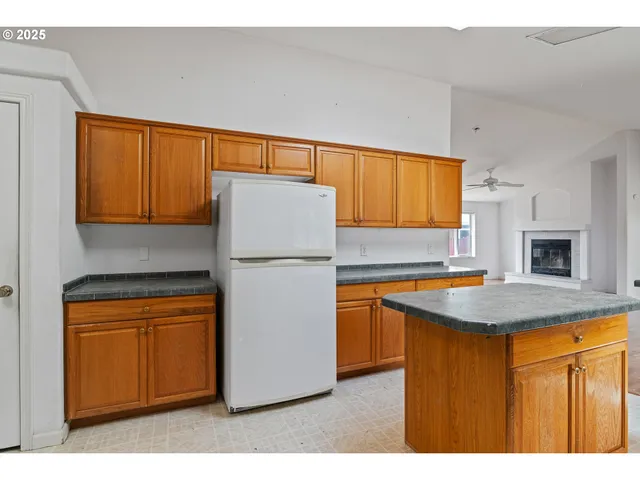 a kitchen with cabinets a sink and a refrigerator