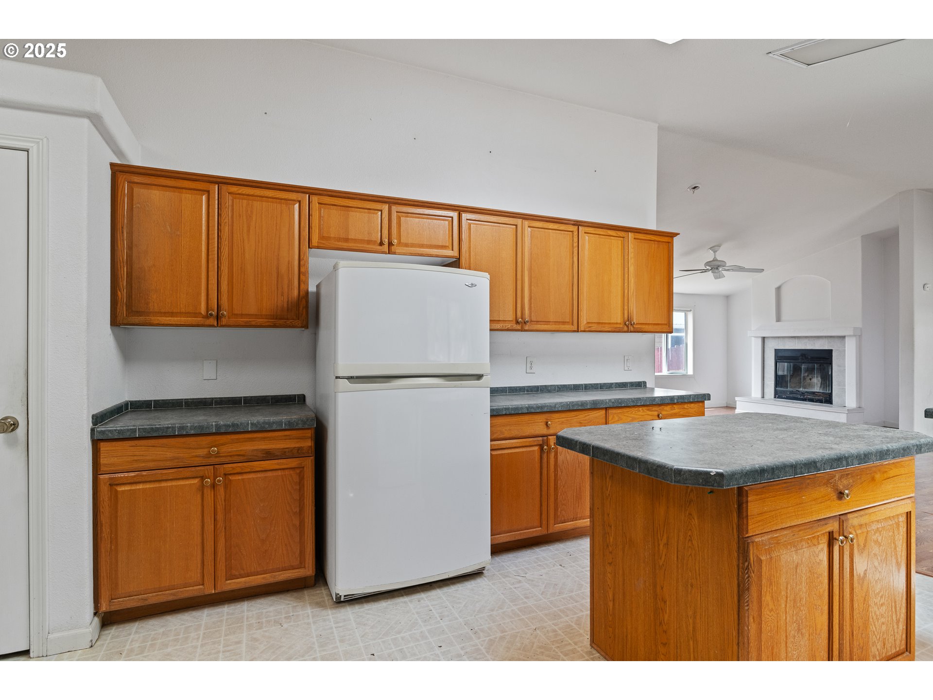 1829 East Willow Street Myrtle Point, OR 97458 - Photo 9 of 37 a kitchen with cabinets a sink and a refrigerator