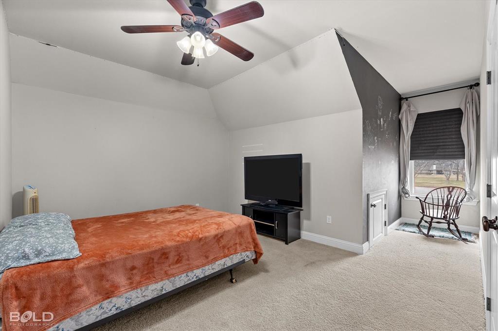 946 Maize Street Bossier City, LA 71111 - Photo 36 of 39 a bedroom with a bed and a flat tv screen on dresser