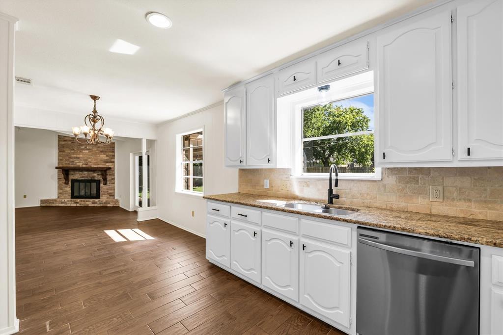 141 Travis Lane Hewitt, TX 76643 - Photo 10 of 31 Kitchen with white cabinetry, granite countertops, and a stainless steel dishwasher